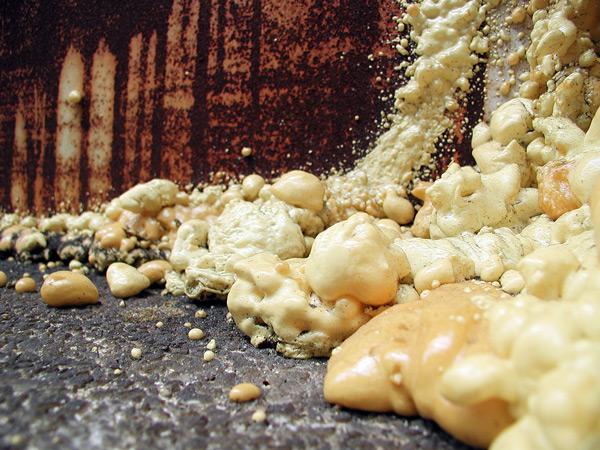 Flowing sealant, hardened, looks like bubbles on
rust.