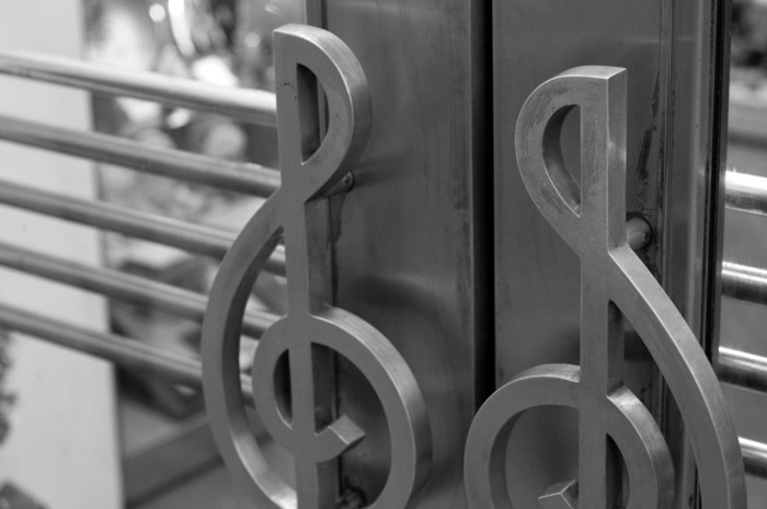 Double doors, with treble clefs for handles.
