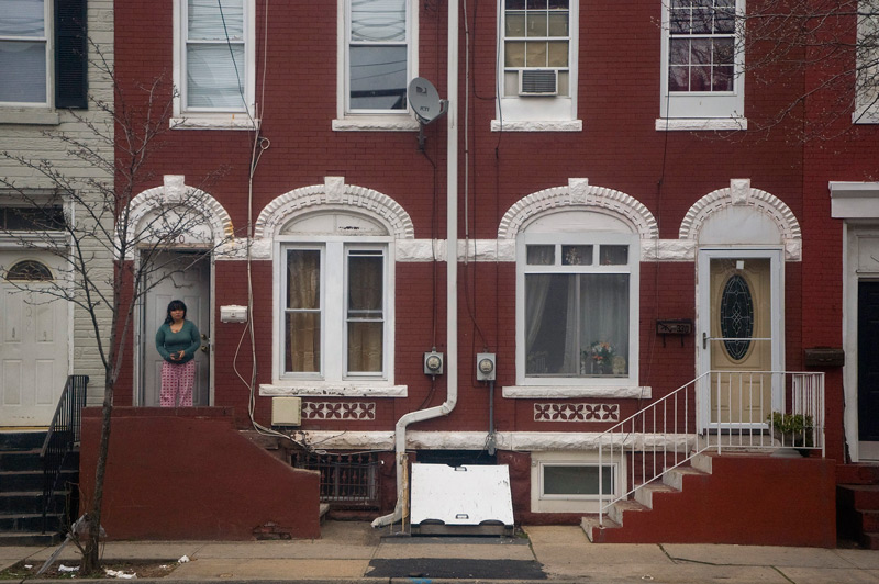 A pair of red row houses, with small differences.