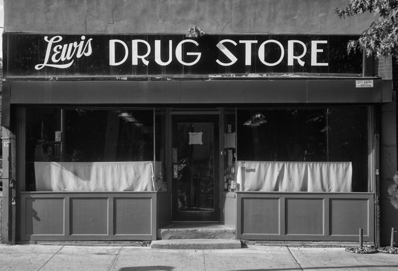 A store front with a dated sign.