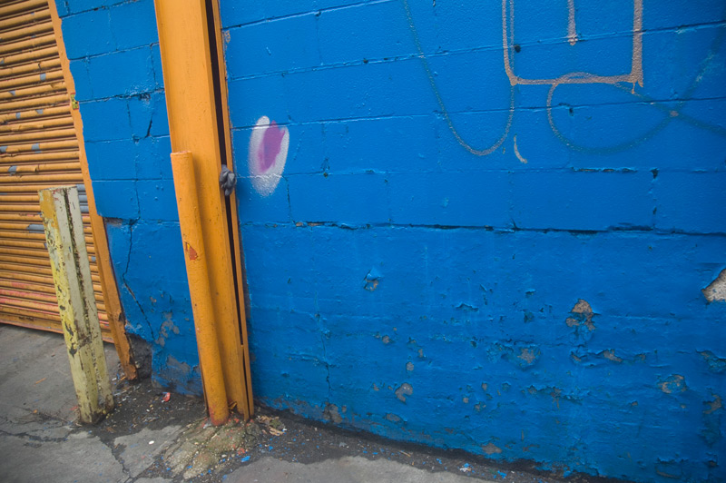 A blue industrial wall, with orange trim.