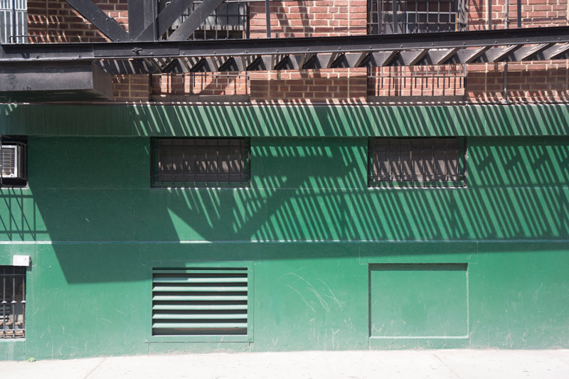 A fire escape's shadows on a wall