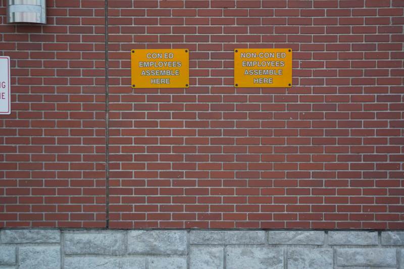 Signs direct people where to line up, depending on status.
